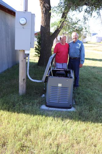 photo by Mary Rumph showing Jerry and Joyce Strobel and their generator